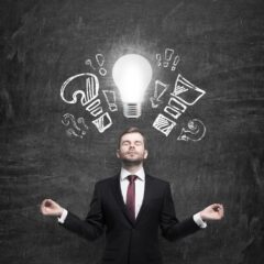 Mediating businessman is brainstorming the business problems. Turned lightbulb and question and exclamation marks.